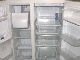 Spotlessly clean empty refrigerator and freezer interior with gleaming shelves after a professional appliance clean